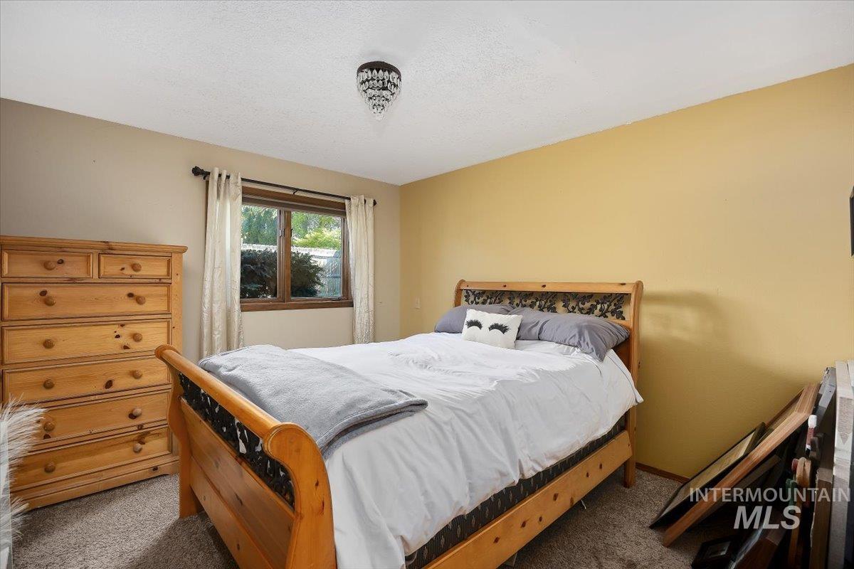 956 Bitterroot Place Twin Falls, ID 83301 - Photo 18 of 48 Carpeted room with a window featuring dark wood trim and white curtains