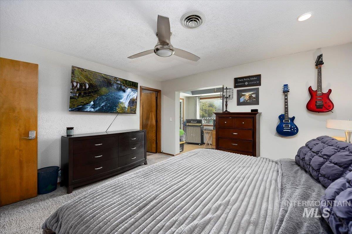 956 Bitterroot Place Twin Falls, ID 83301 - Photo 21 of 48 Carpeted room featuring a ceiling fan with integrated lighting, a recessed ceiling light, and a brown wood-finish door