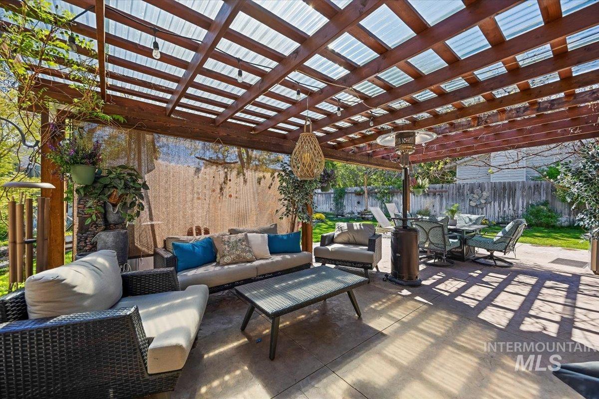 956 Bitterroot Place Twin Falls, ID 83301 - Photo 28 of 48 Spacious patio featuring a wood pergola with a translucent roof, string lighting, and a concrete slab