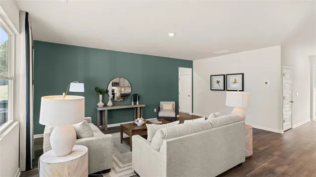 a living room with furniture and a large window