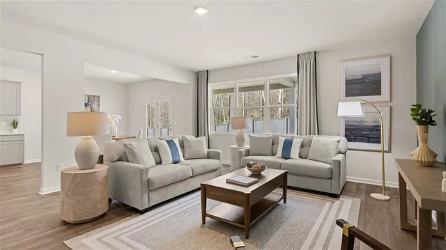 a living room with furniture kitchen view and a dining table