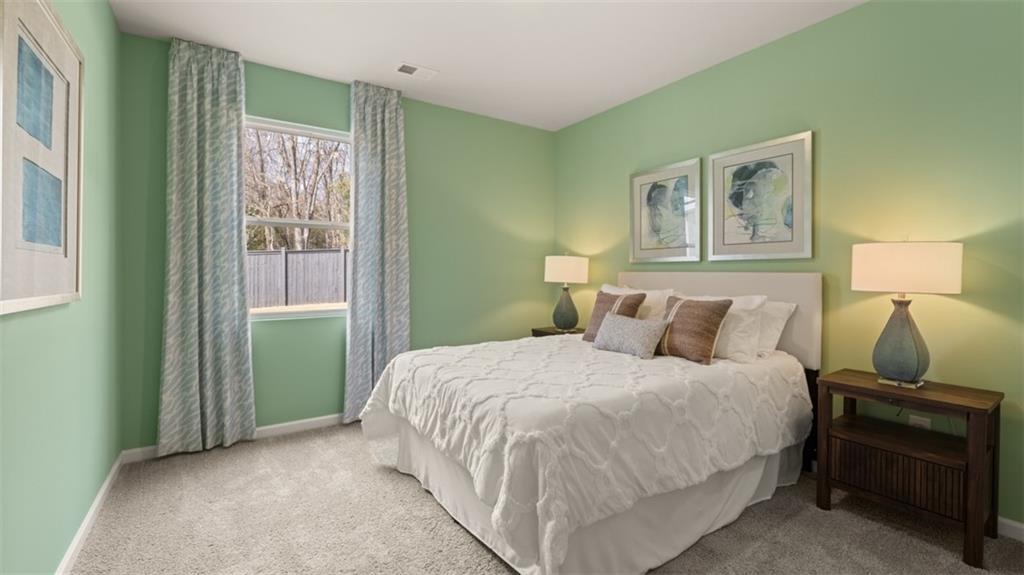 398 Bullock Pass Jefferson, GA 30549 - Photo 17 of 44 a bedroom with a bed and wooden floor