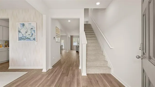 a view of a hallway with wooden floor and entryway