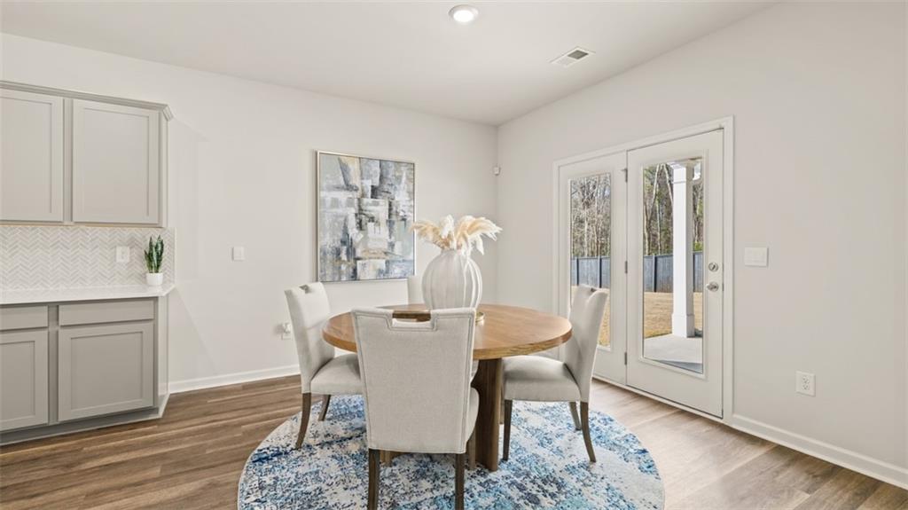 398 Bullock Pass Jefferson, GA 30549 - Photo 8 of 44 a view of a dining room with furniture window and wooden floor