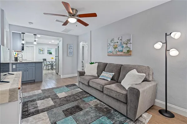 a living room with furniture and a chandelier