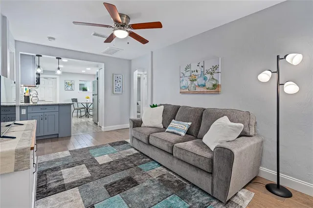 a living room with furniture and a chandelier