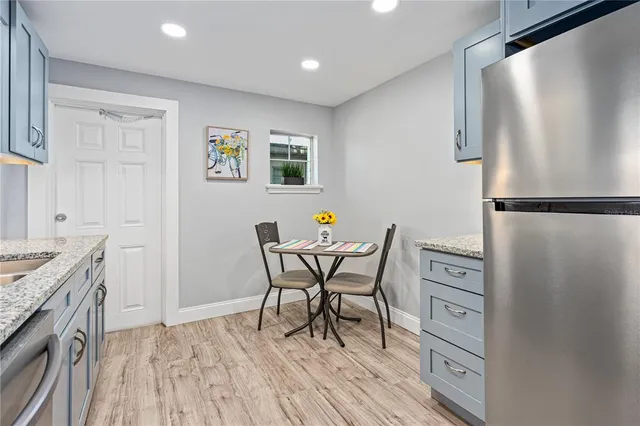 a view of a kitchen with a table and chairs