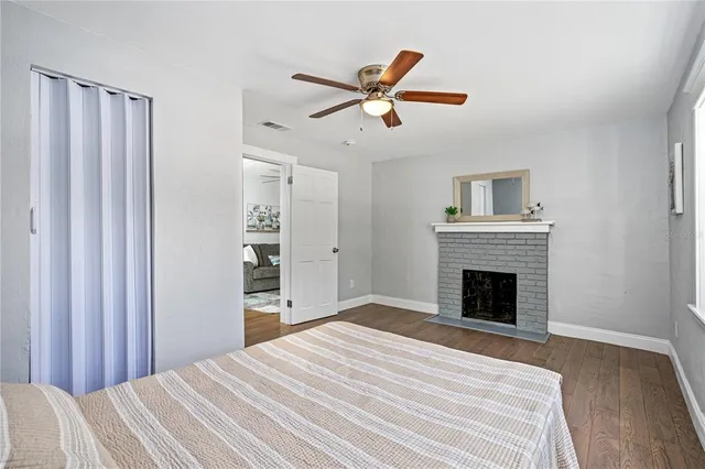 a bedroom with a bed and a ceiling fan