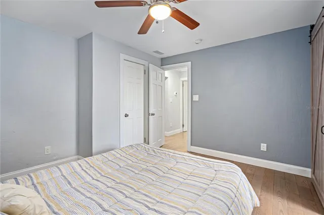 a bedroom with a bed and a chandelier