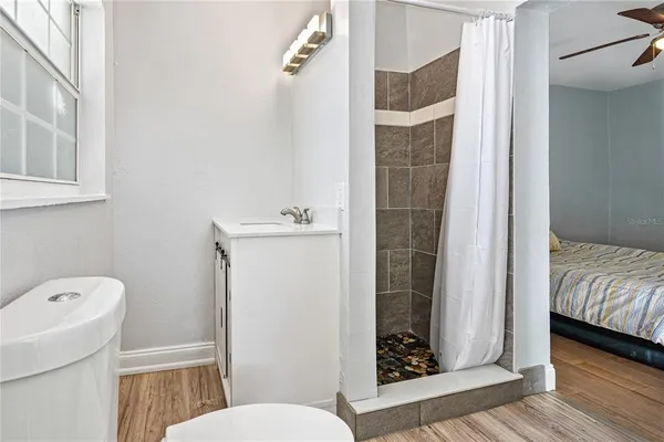 a bathroom with a toilet and a shower