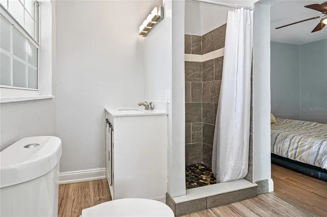 a bathroom with a toilet and a shower