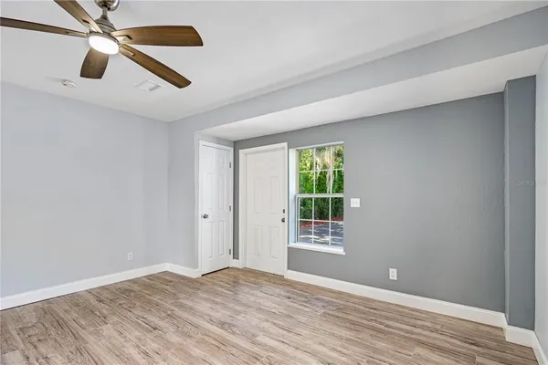 wooden floor in an empty room with a window