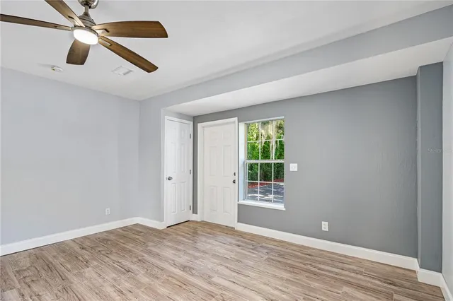 wooden floor in an empty room with a window