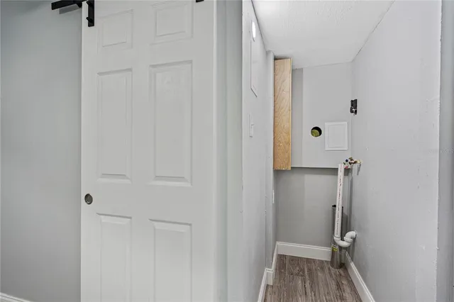 a view of a hallway with wooden floor