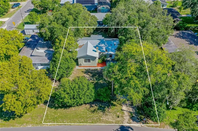 an aerial view of a house with a yard