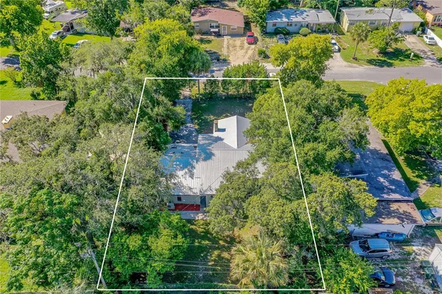 an aerial view of house with yard