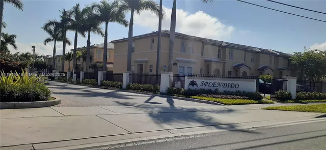 a view of a fountain with potted plants