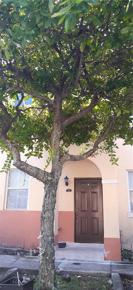 8091 West 36th Avenue, Unit 3 Hialeah, FL 33018 - Photo 3 of 16 a front view of a house with a tree