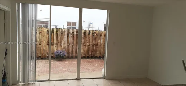 a kitchen with granite countertop a refrigerator and a sink