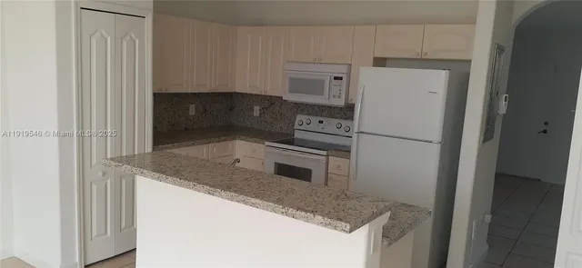 a kitchen with a sink and large cabinets