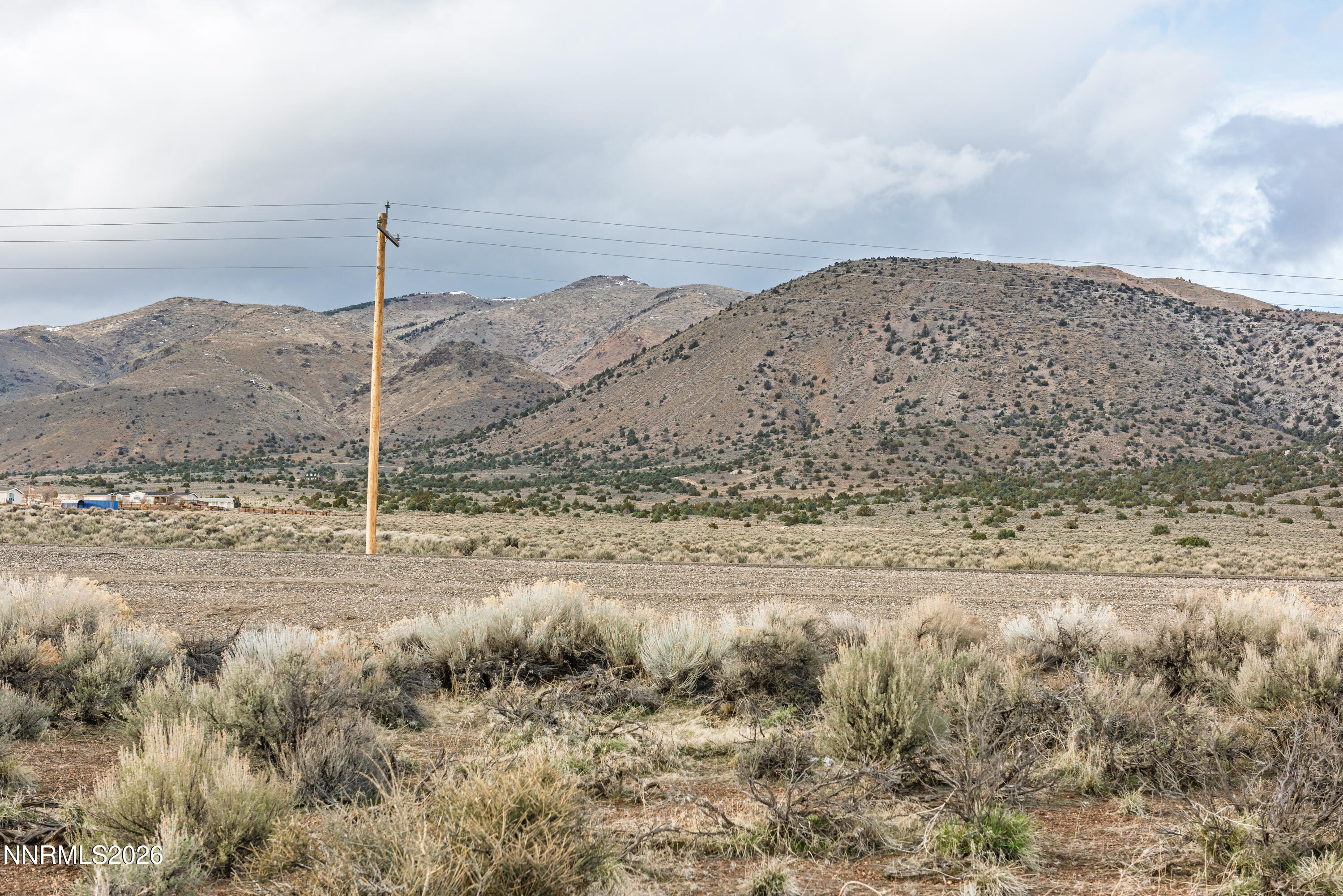 4221 Highway 208 Topaz Ranch Estates, NV 89444 - Photo 25 of 29 a view of a dry field with mountains in the background