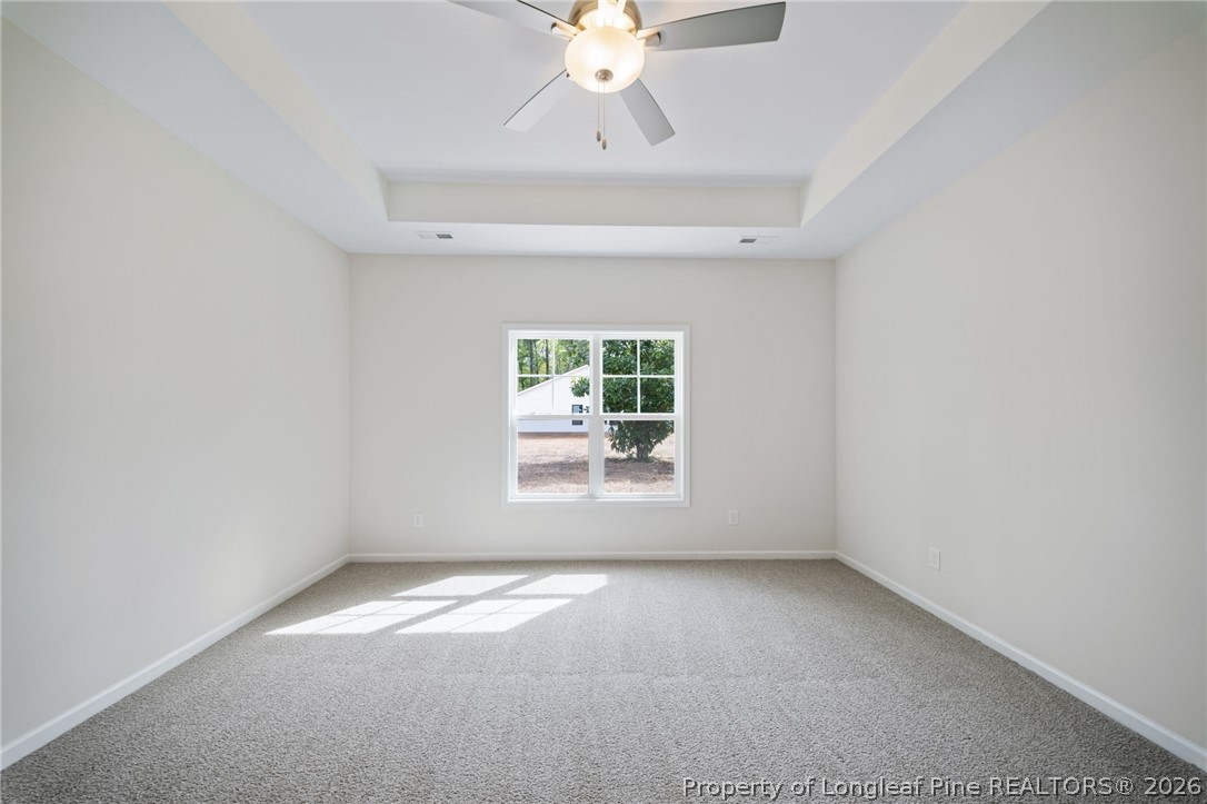 4052 Lofton Street Wade, NC 28395 - Photo 17 of 22 an empty room with a window and a ceiling fan