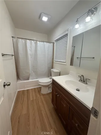 a bathroom with a sink a toilet a tub and shower