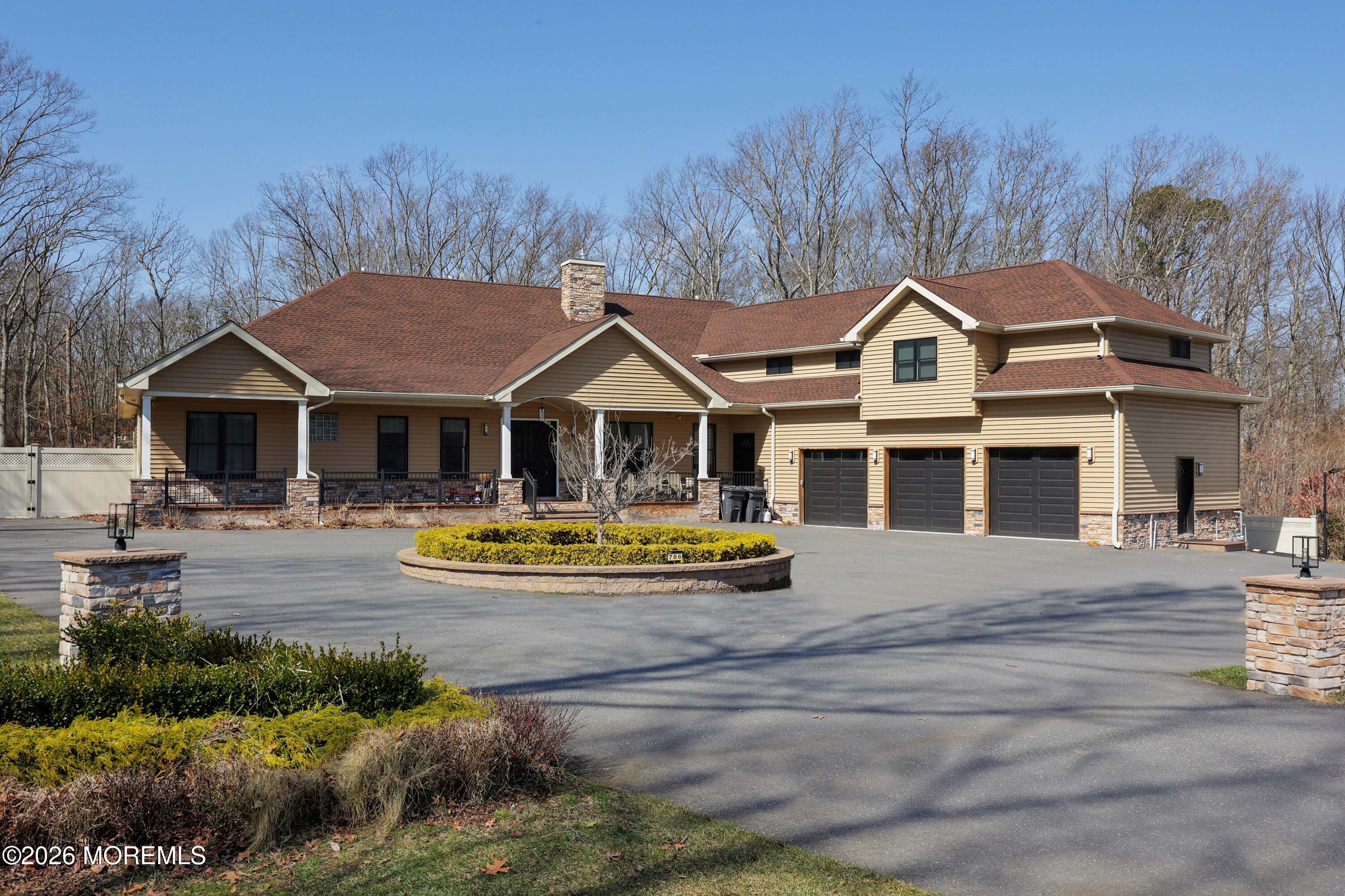 a front view of a house with yard and green space