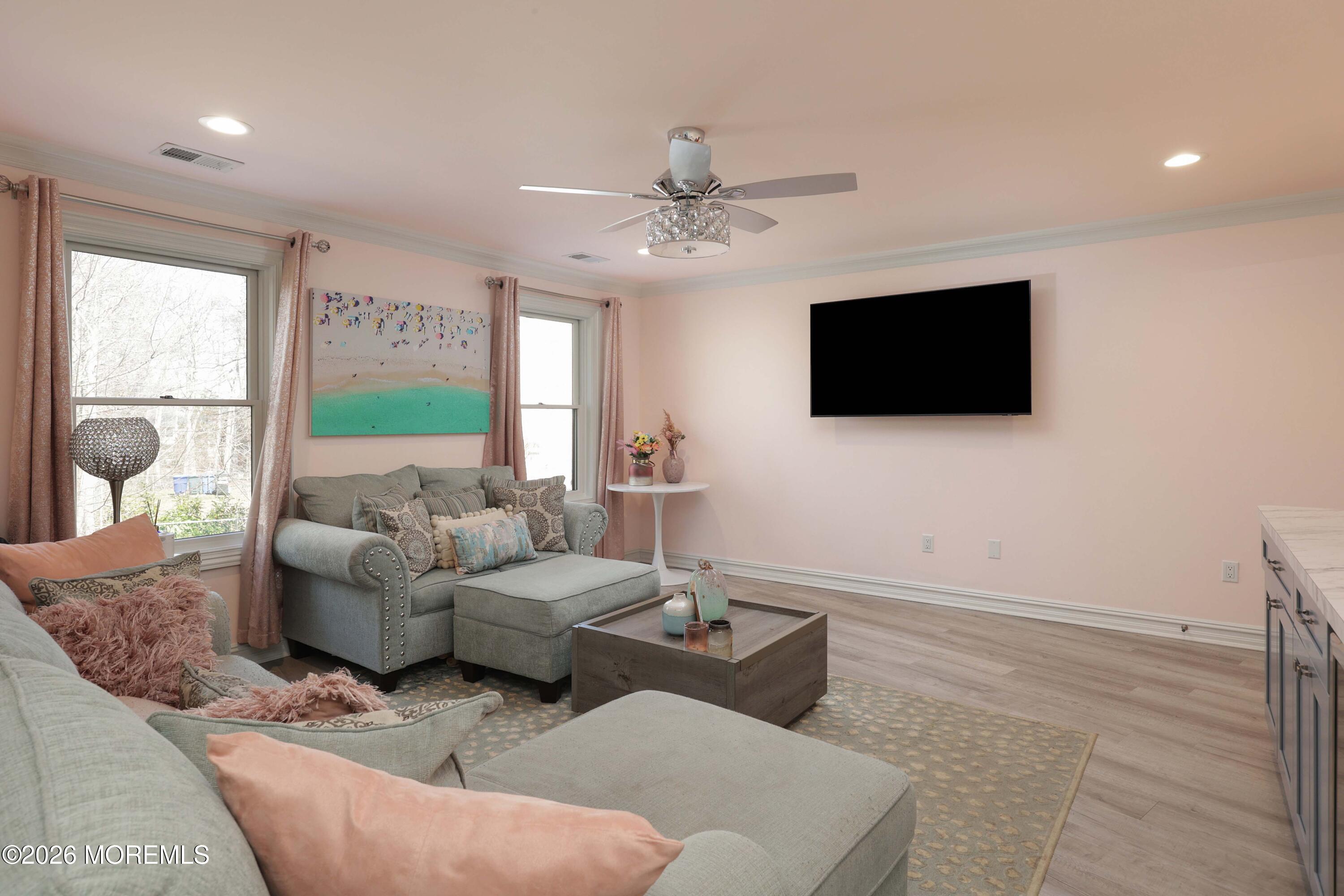 786 Holly Berry Lane Brick, NJ 08724 - Photo 24 of 52 a living room with furniture a flat screen tv and a large window