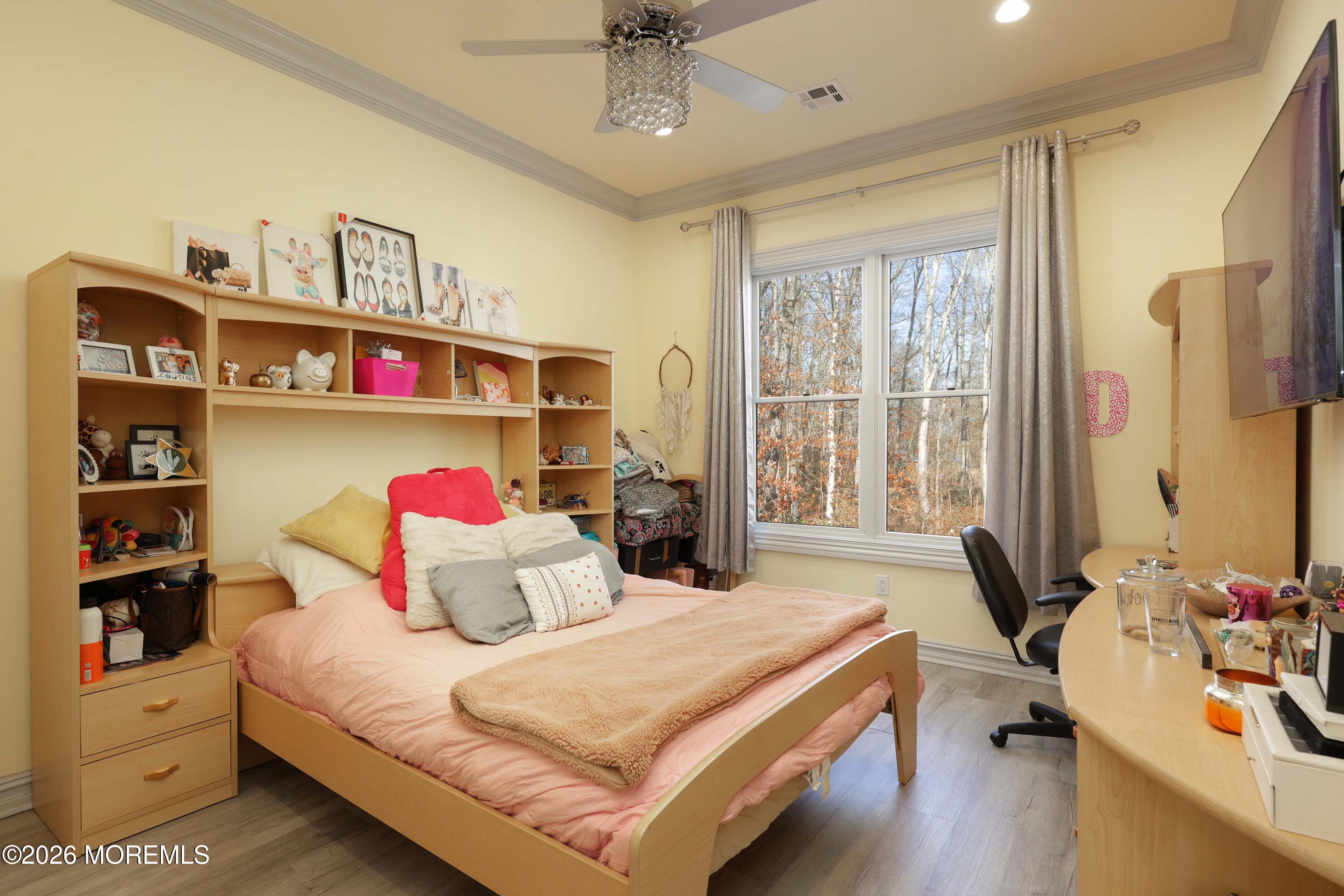 786 Holly Berry Lane Brick, NJ 08724 - Photo 26 of 52 a bedroom with a bed and a chandelier