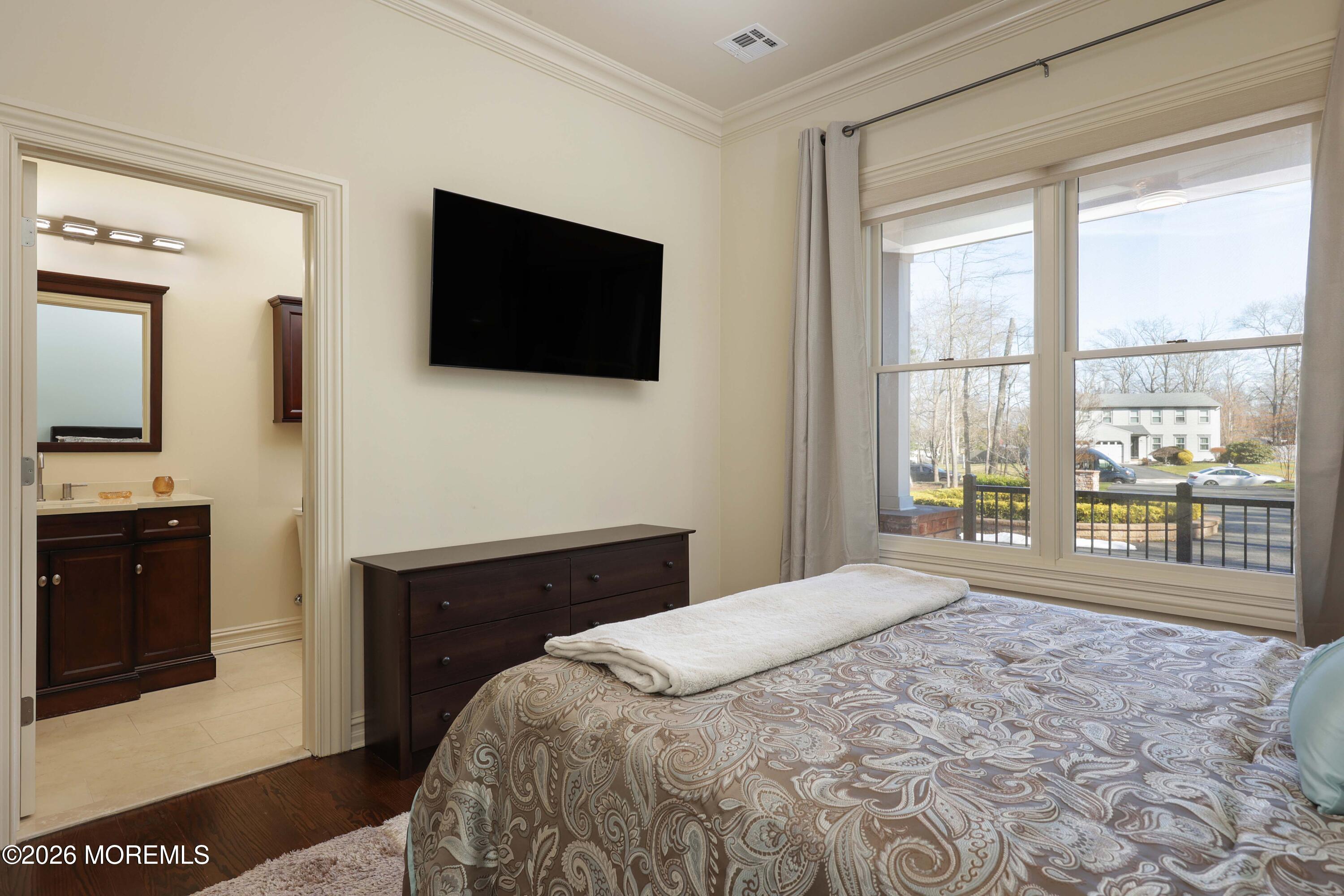 786 Holly Berry Lane Brick, NJ 08724 - Photo 30 of 52 a spacious bedroom with a large bed and a flat tv screen on dresser