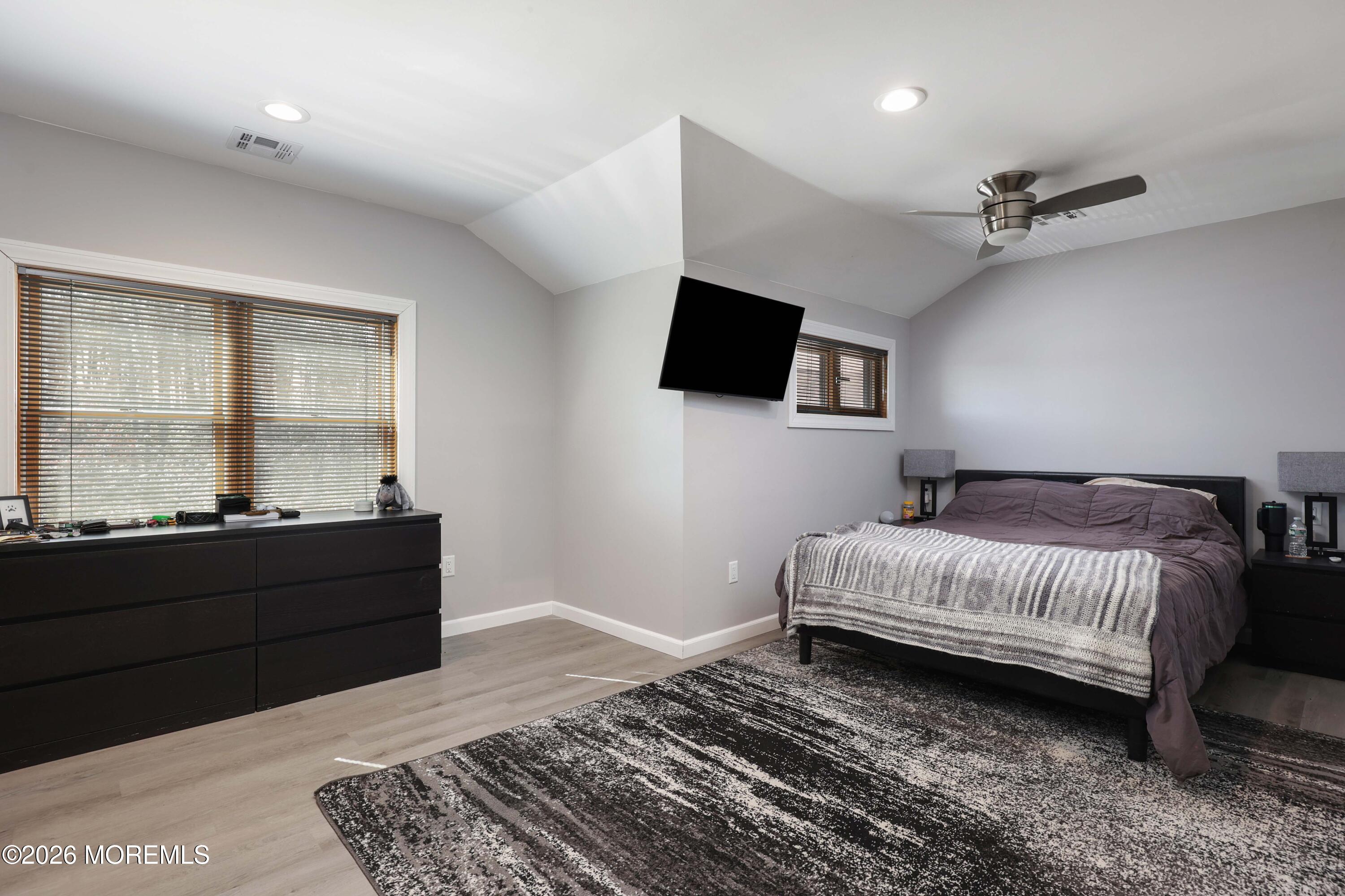786 Holly Berry Lane Brick, NJ 08724 - Photo 35 of 52 a living room with a bed furniture and a flat screen tv