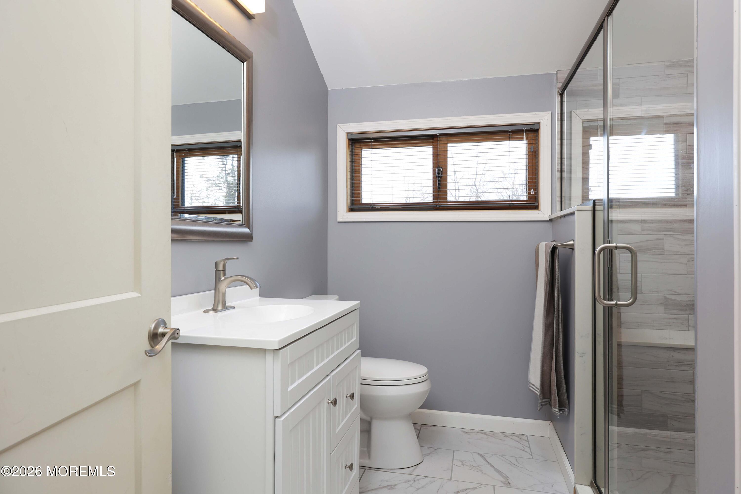 786 Holly Berry Lane Brick, NJ 08724 - Photo 36 of 52 a bathroom with a toilet sink and mirror