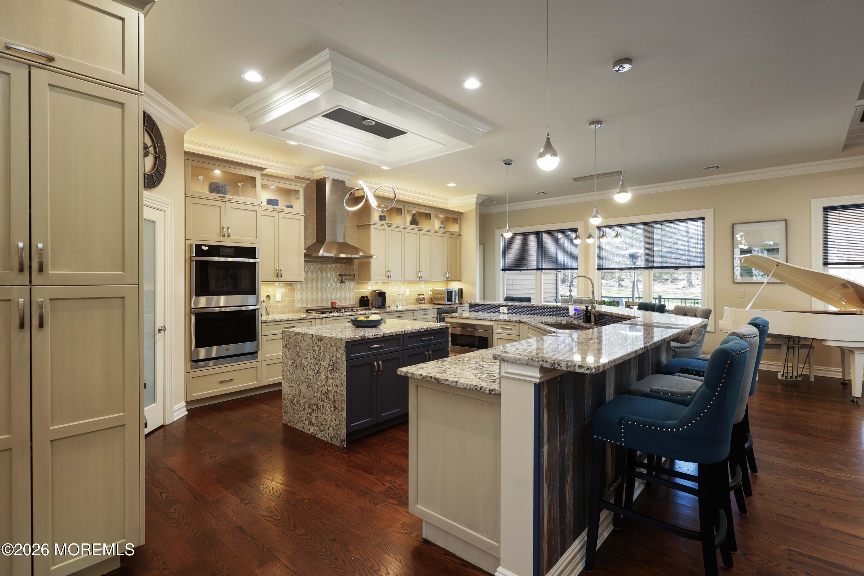 786 Holly Berry Lane Brick, NJ 08724 - Photo 10 of 52 a kitchen with stainless steel appliances granite countertop a refrigerator a stove and a dining table with wooden floor
