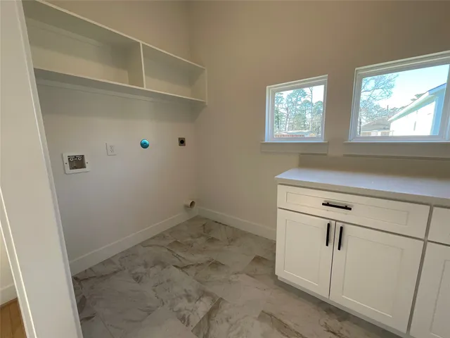a view of a kitchen with white cabinets