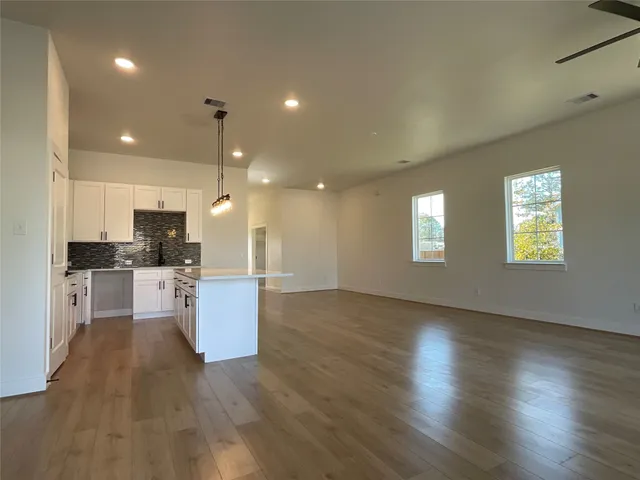 a view of kitchen with cabinets and wooden floor