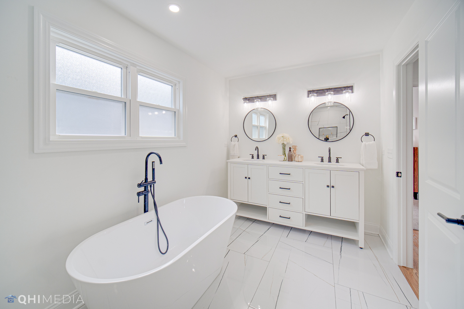 5459 West Grace Street Chicago, IL 60641 - Photo 17 of 24 a bathroom with a sink and a large mirror