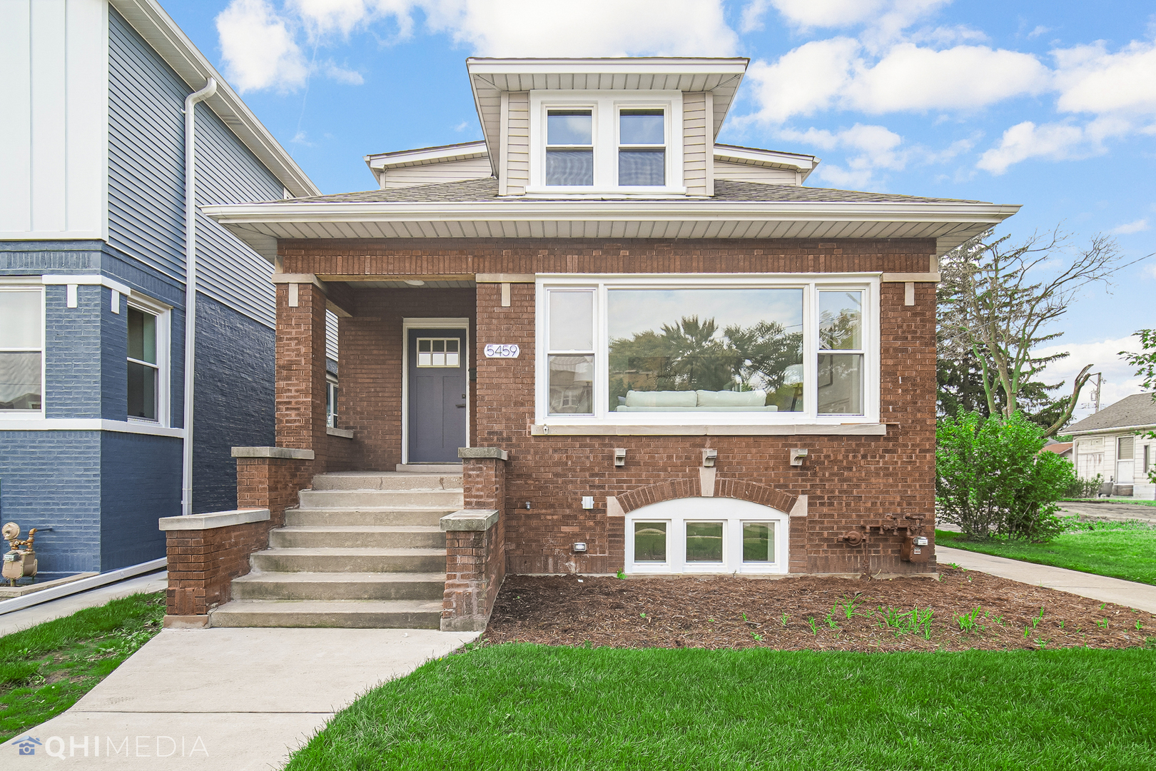 5459 West Grace Street Chicago, IL 60641 - Photo 2 of 24 a front view of a house with a yard