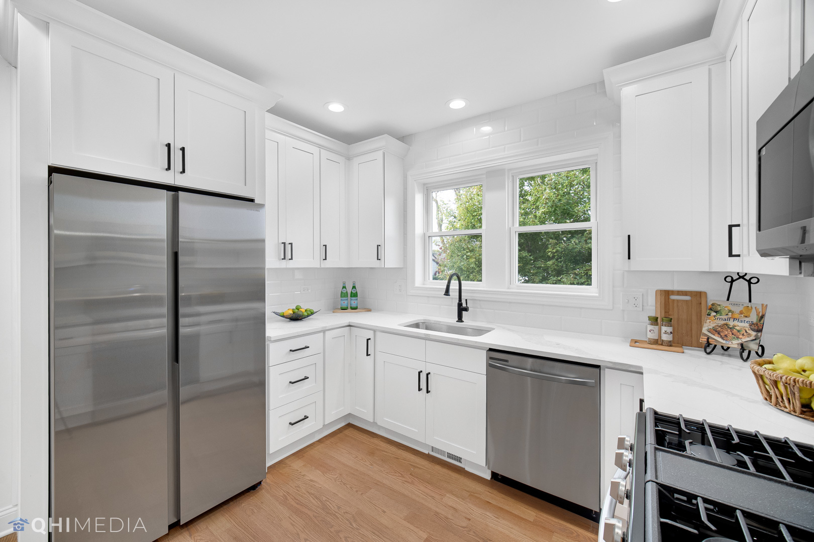 5459 West Grace Street Chicago, IL 60641 - Photo 7 of 24 a kitchen with a sink stainless steel appliances cabinets and a window