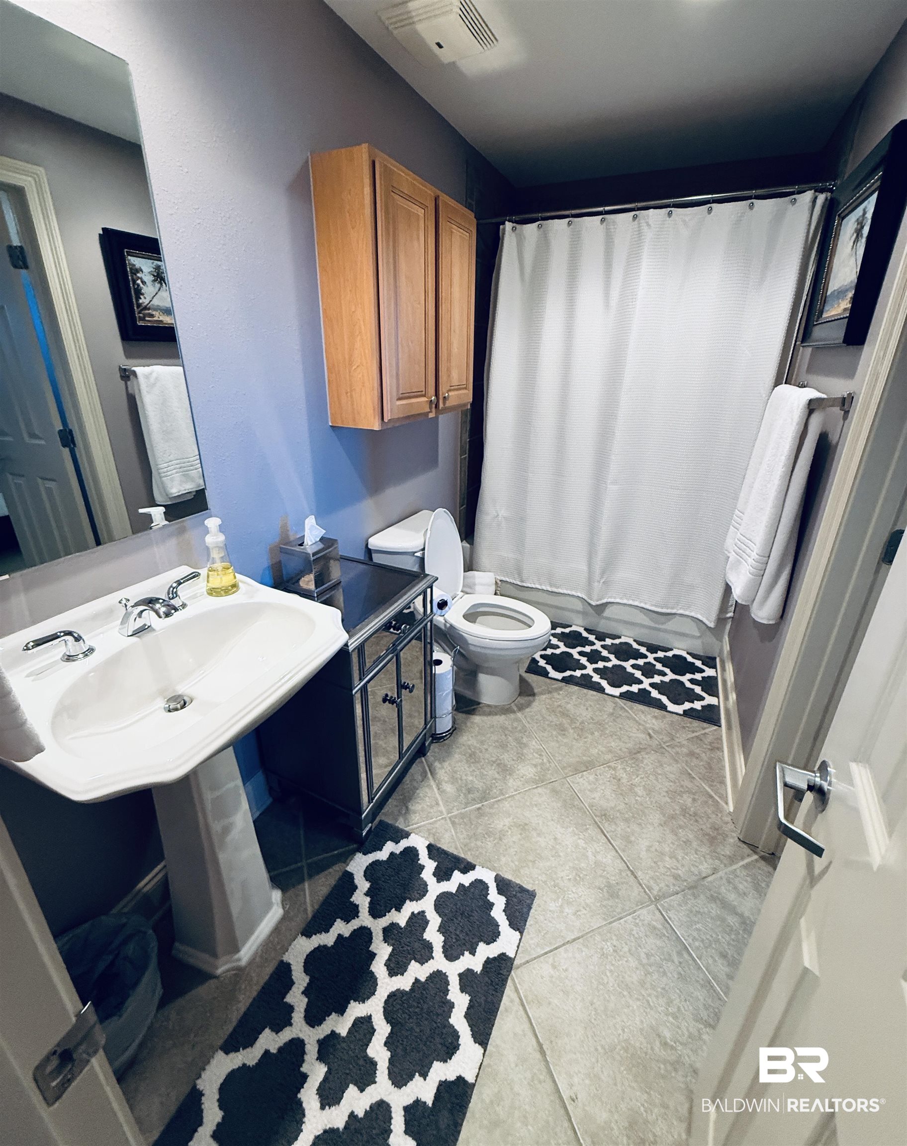 27800 Canal Road, Unit 409 Orange Beach, AL 36561 - Photo 11 of 22 Bathroom with shower / bath combination with curtain and light tile patterned floors