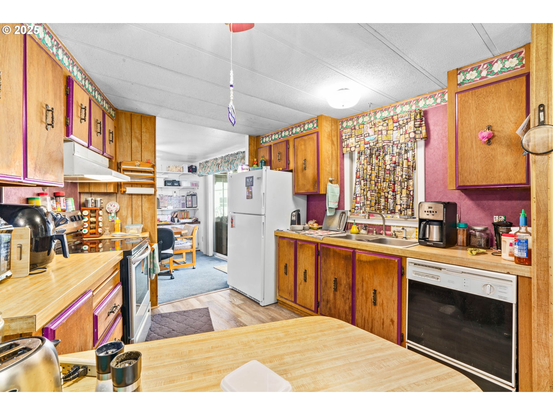 82966 Minnick Road Dexter, OR 97431 - Photo 21 of 29 a open kitchen with stainless steel appliances kitchen island granite countertop a refrigerator and a stove top oven