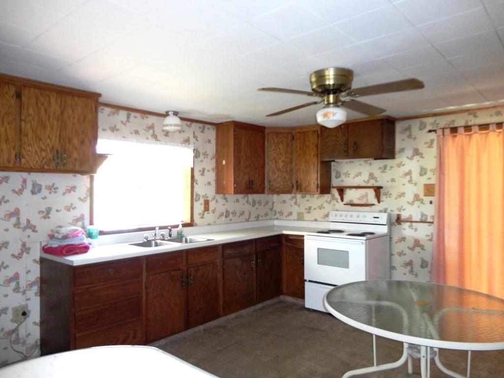 140 Riverview Road Hayfork, CA 96041 - Photo 3 of 21 a kitchen with a sink dishwasher a stove a dining table and chairs