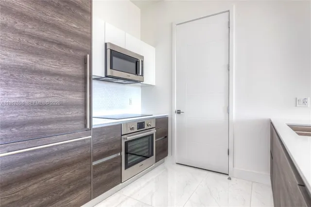 a kitchen with a stove and a microwave