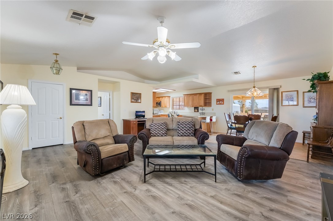 3631 South Blagg Road Pahrump, NV 89048 - Photo 9 of 47 An inviting great room with wood flooring extends seamlessly to the kitchen and dining area.