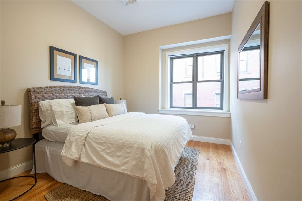 191 Main Street, Unit 2A Gloucester, MA 01930 - Photo 6 of 15 a bedroom with a bed and a window