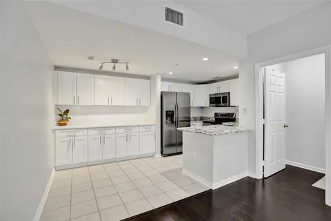 a kitchen with white cabinets and white appliances