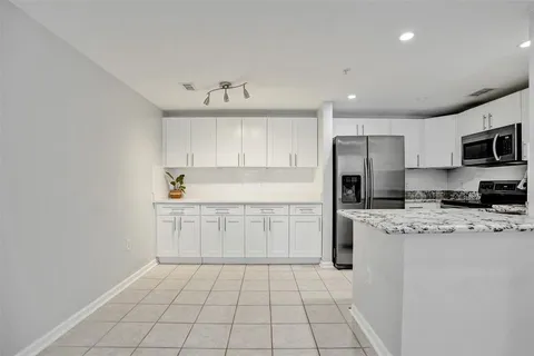 a kitchen with stainless steel appliances a refrigerator sink and cabinets