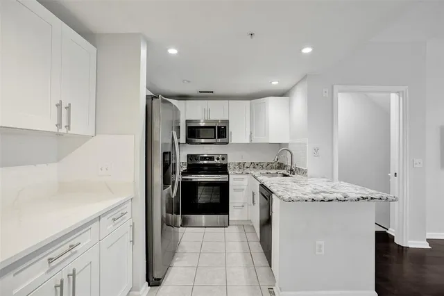 a kitchen with a sink stove and refrigerator