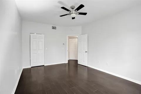 a view of a room with furniture and a ceiling fan