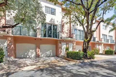 a view of a yard with brick house and a large tree
